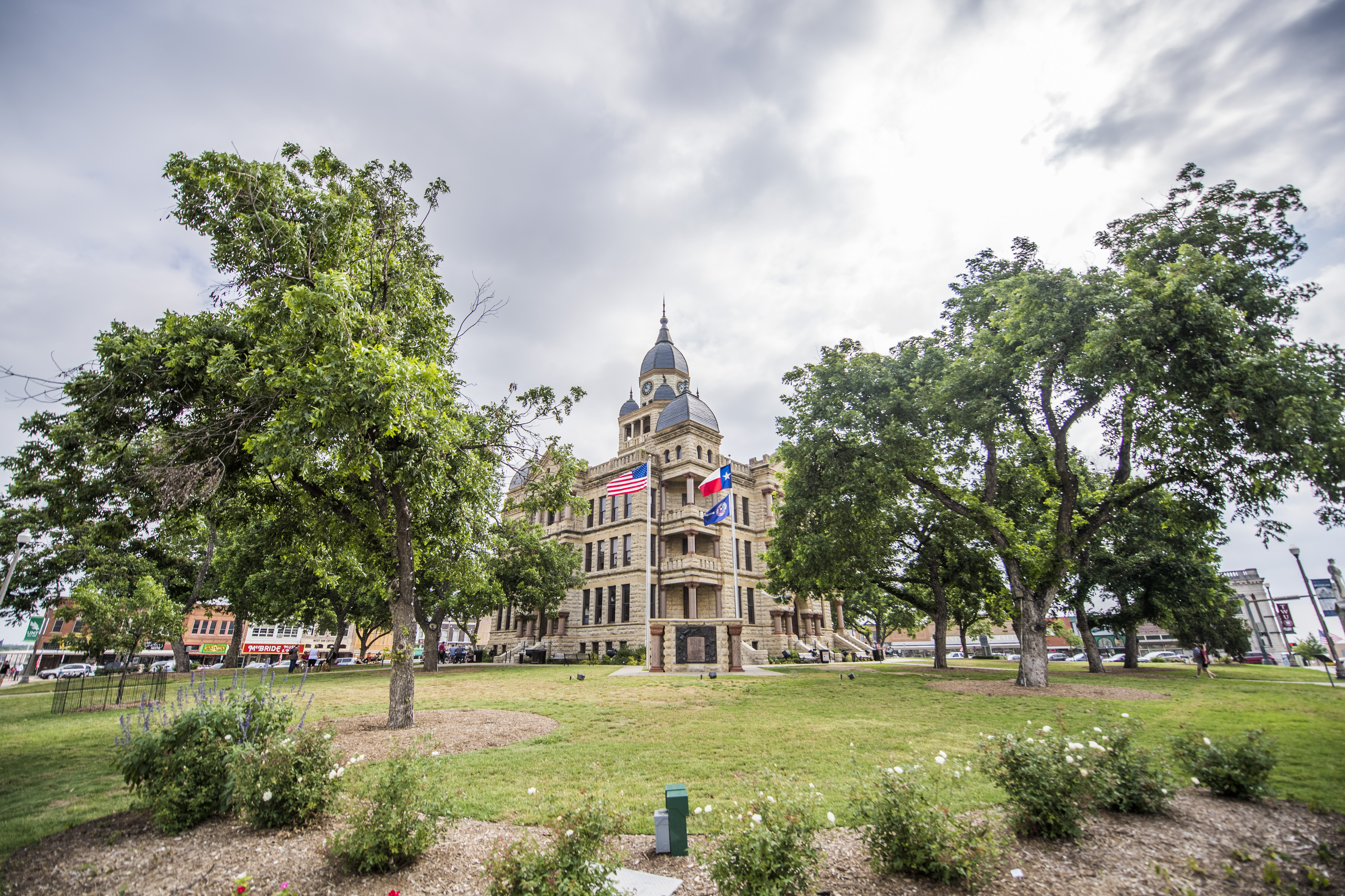 The historic courthouse on Denton's Square, framed by trees.